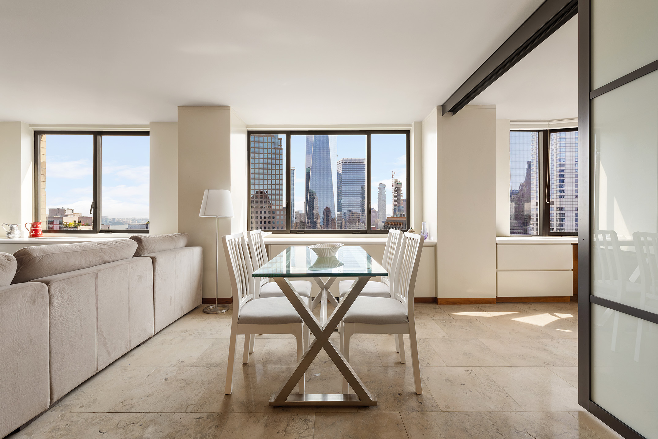 200 Rector Place, Unit 36LM Manhattan, NY 10280 - Photo 4 of 15 a living room with a table and chairs