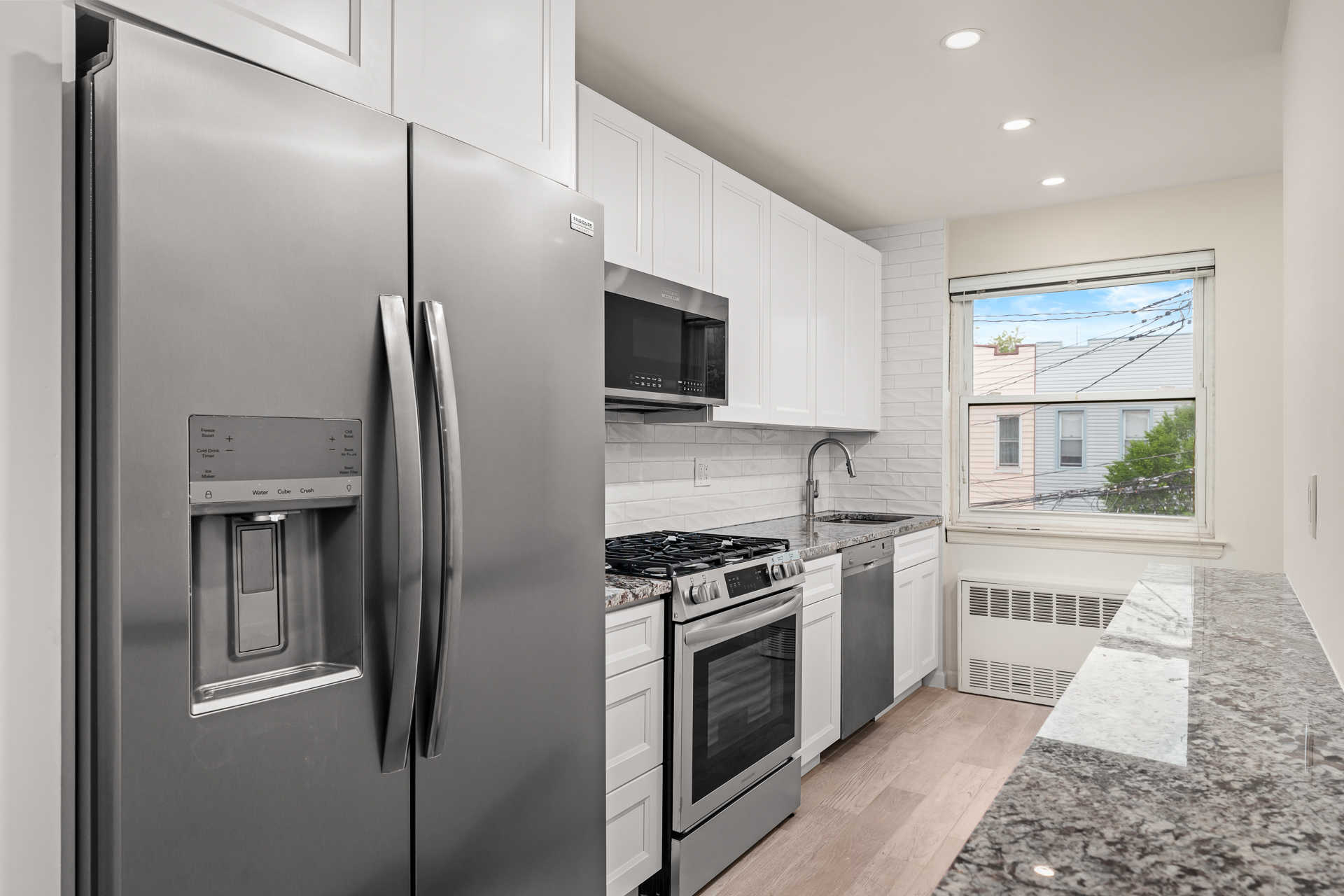 412 Fairview Avenue, Unit 1 Queens, NY 11385 - Photo 2 of 9 a kitchen with stainless steel appliances granite countertop a refrigerator a stove and a sink