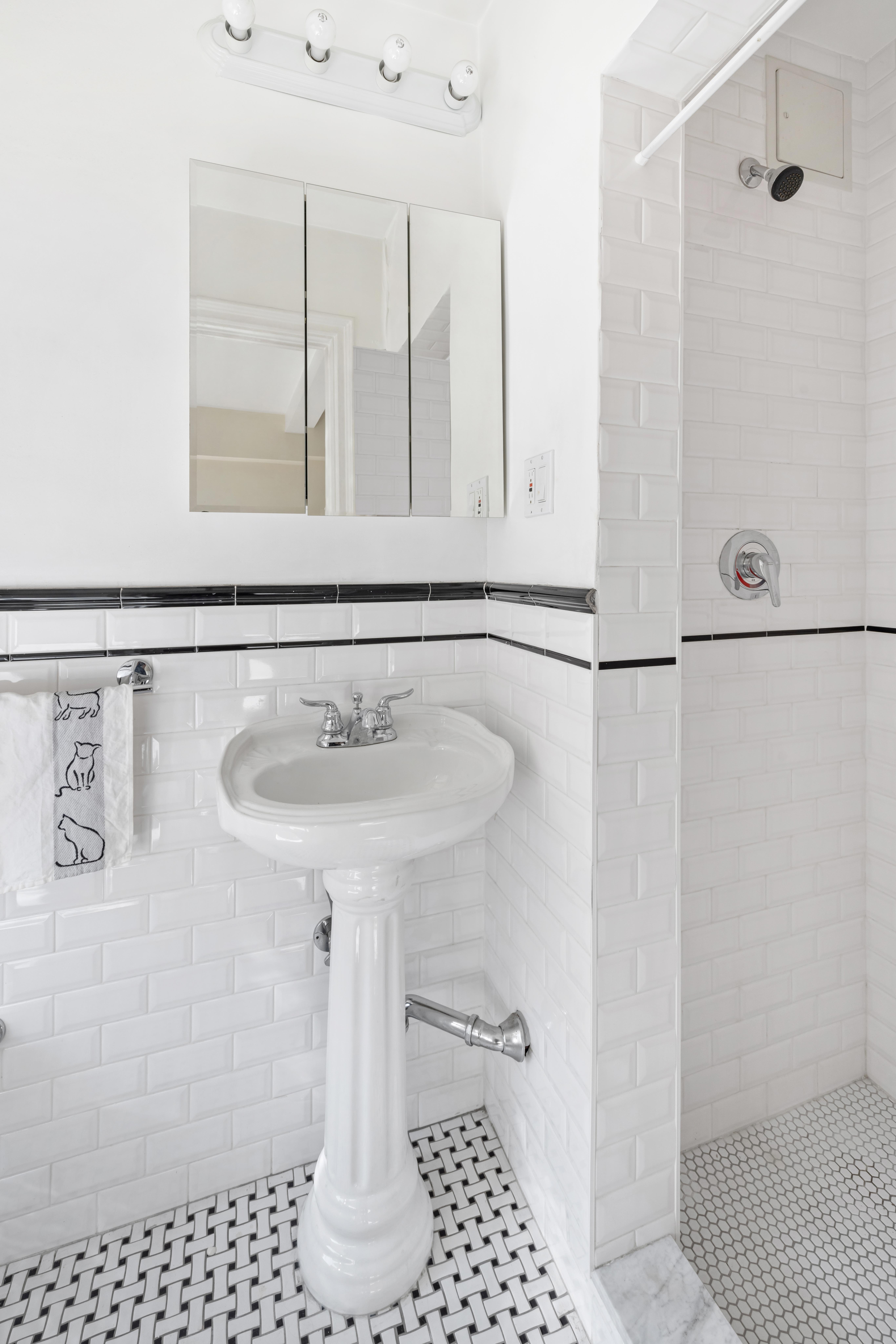 444 Central Park West, Unit 5E Manhattan, NY 10025 - Photo 11 of 14 a bathroom with a sink a shower and a mirror