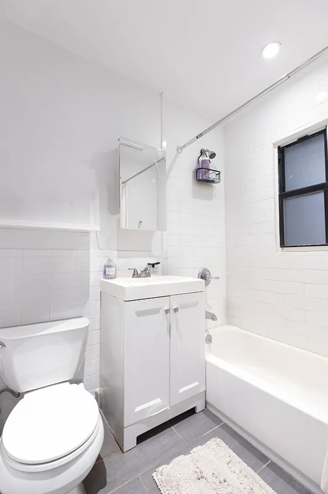 1582 York Avenue, Unit 5A Manhattan, NY 10028 - Photo 3 of 9 a bathroom with a sink a toilet and bathtub