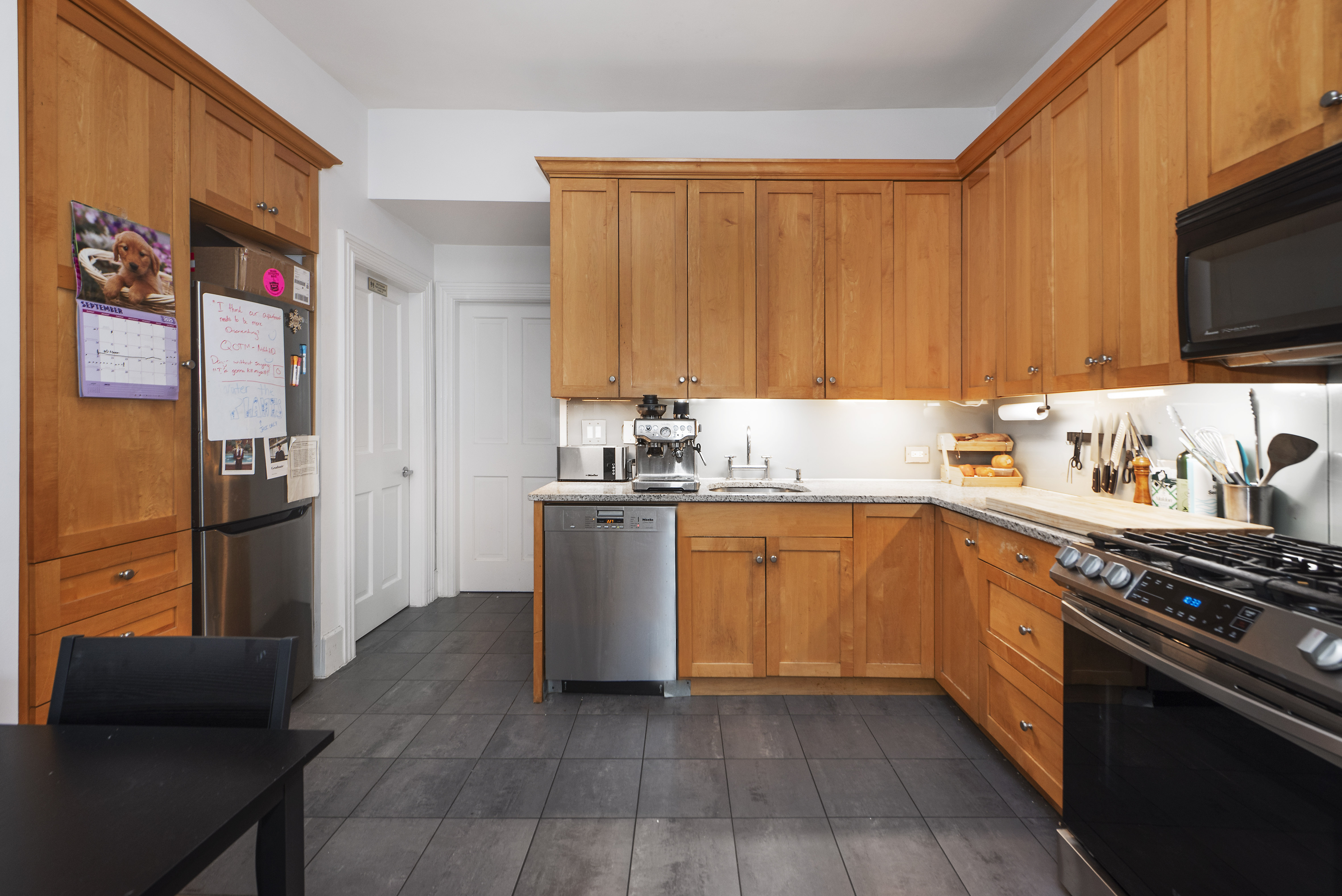 249 East Houston Street, Unit 4 Manhattan, NY 10002 - Photo 1 of 10 a kitchen with stainless steel appliances granite countertop a refrigerator stove top oven and sink