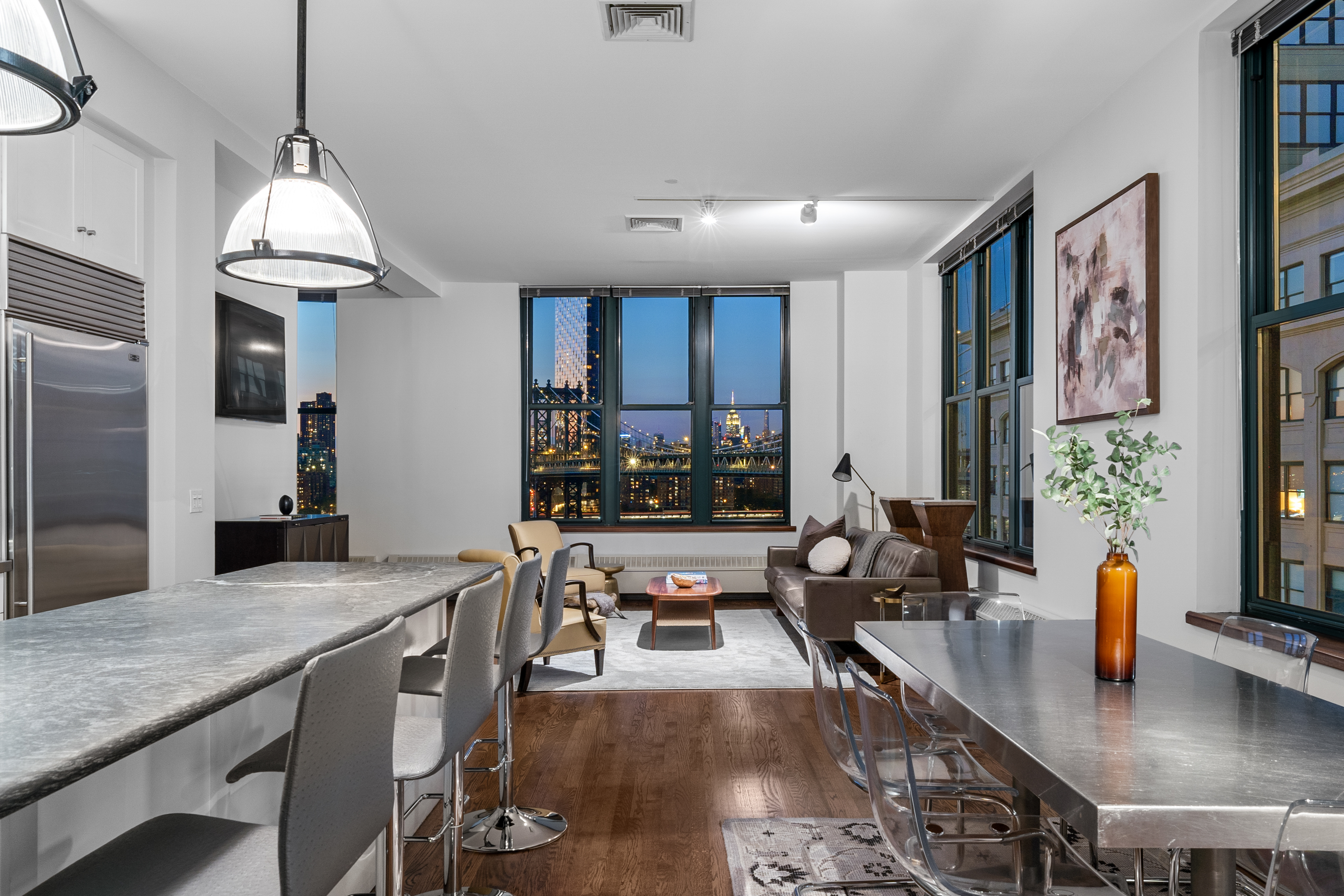 30 Main Street, Unit PHB Brooklyn, NY 11201 - Photo 22 of 33 a view of a kitchen with kitchen island granite countertop a large window and stainless steel appliances
