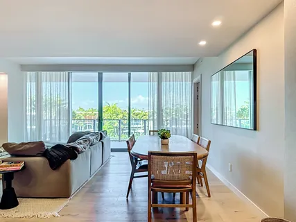 a bedroom with a large bed and a flat screen tv