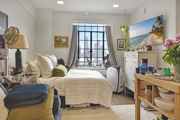 a bedroom with furniture and a window