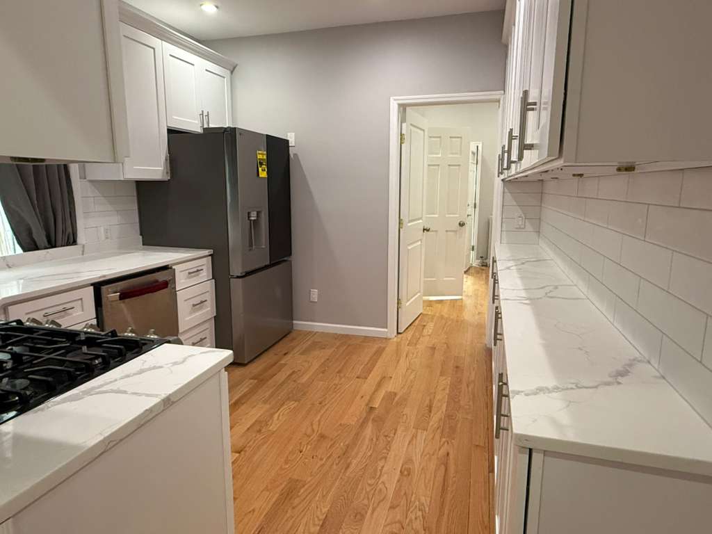 641 East 4th Street, Unit 1 Brooklyn, NY 11218 - Photo 9 of 15 a kitchen with a refrigerator and a stove