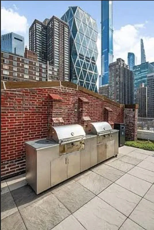 a view of a brick building next to a yard
