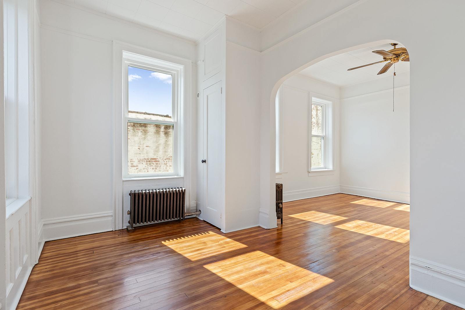 4401 4th Avenue, Unit D4 Brooklyn, NY 11220 - Photo 2 of 7 a view of empty room with wooden floor and fan