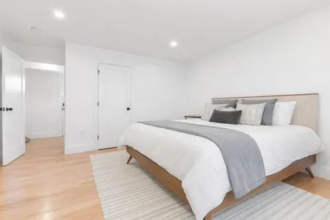 a bedroom with a bed and a night stand