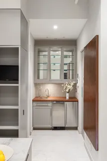 a bathroom with a tub a sink and mirror