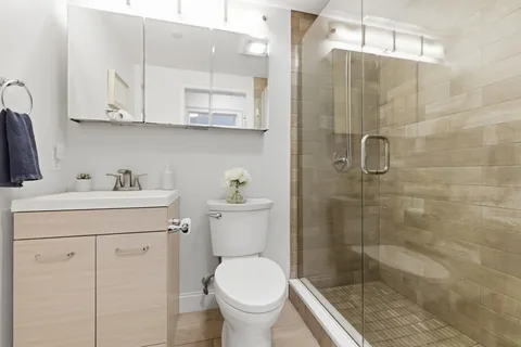 a bathroom with a sink toilet and shower