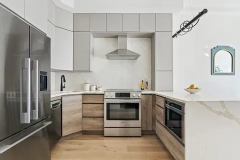 a kitchen with stainless steel appliances a stove and a refrigerator