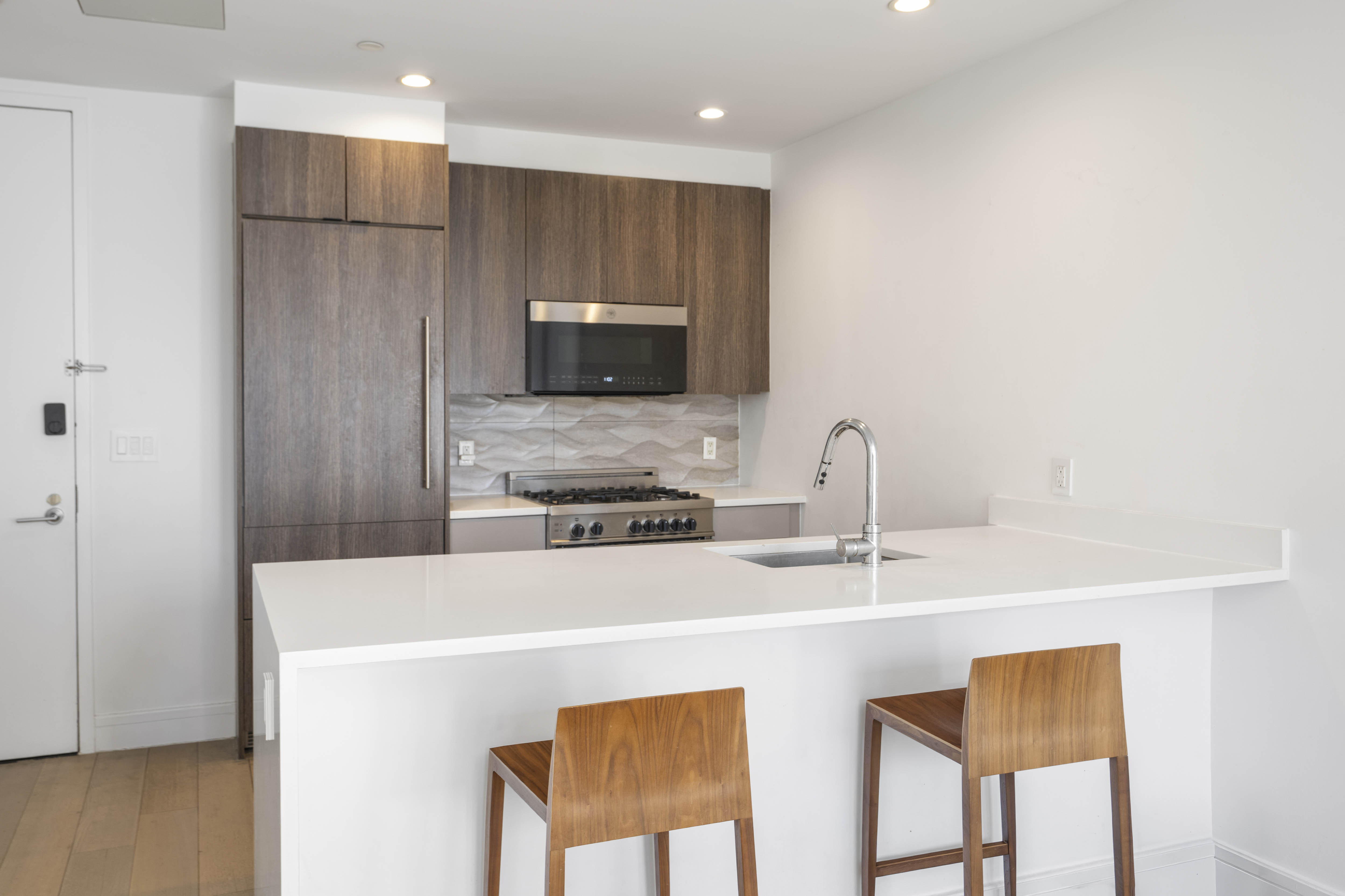 695 6th Avenue, Unit 2P Brooklyn, NY 11215 - Photo 2 of 15 a kitchen with stainless steel appliances a microwave a sink and a refrigerator