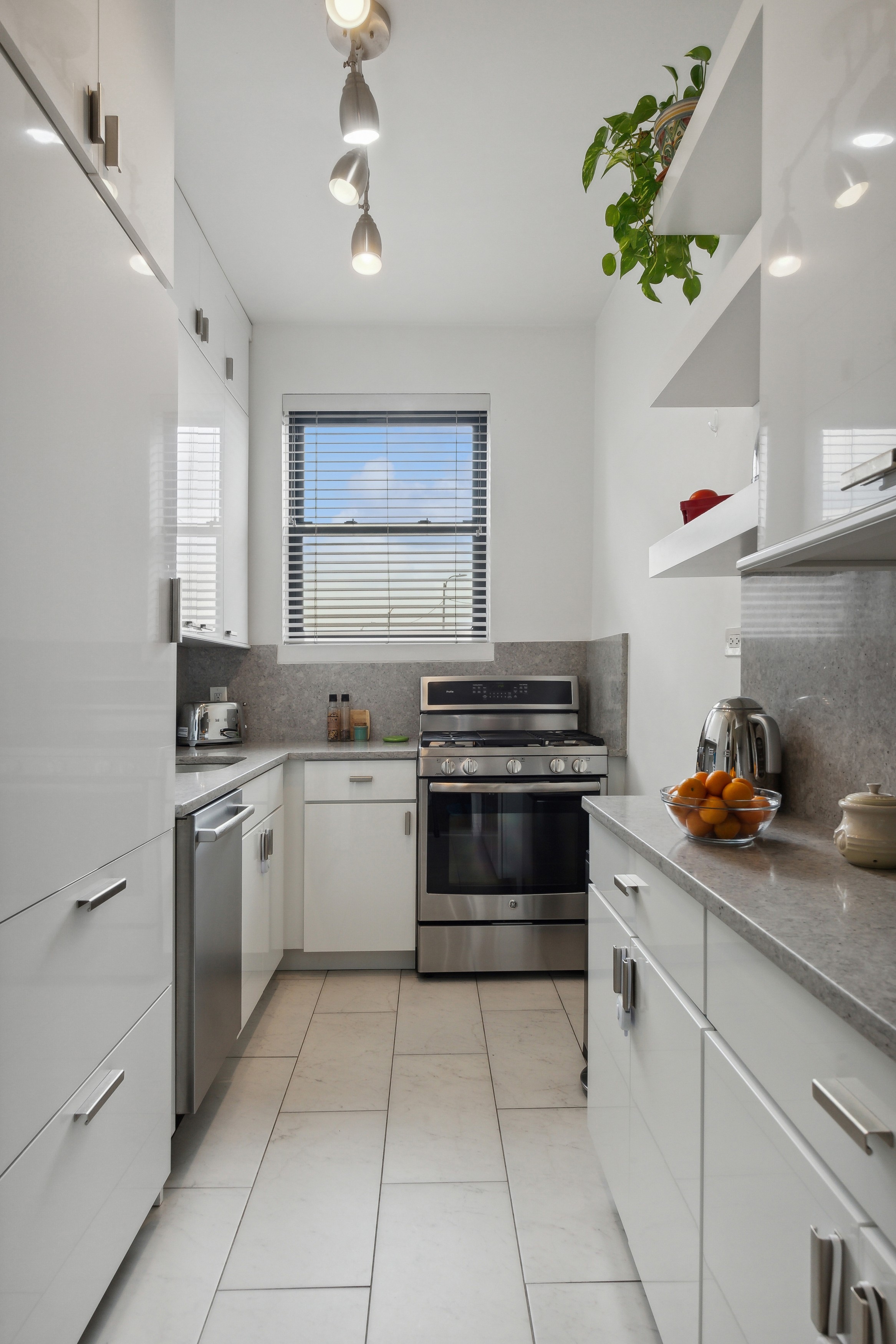 158-18 Riverside Drive West, Unit 2E Manhattan, NY 10032 - Photo 5 of 22 a kitchen with a stove a sink and cabinets