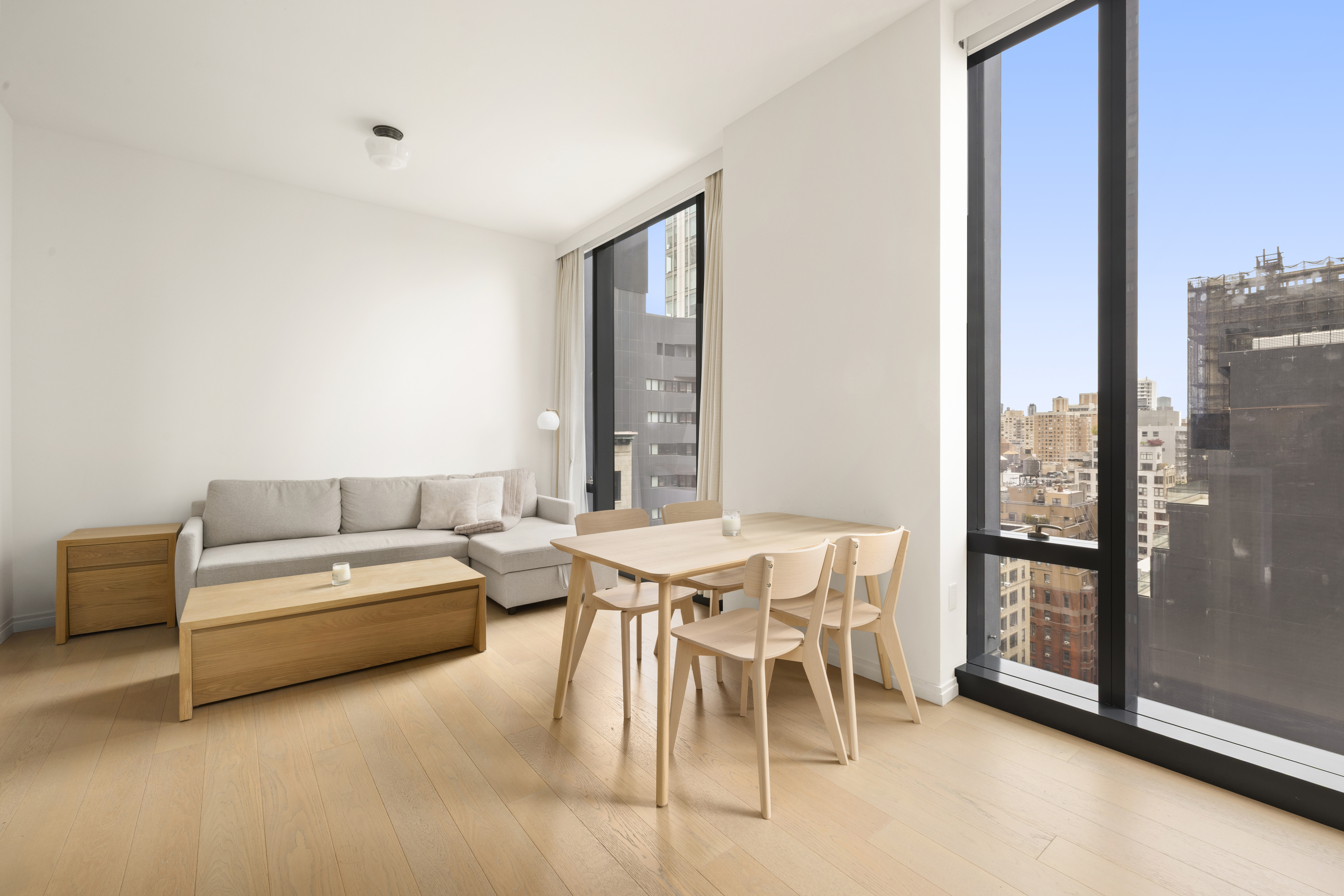 277 5th Avenue, Unit 21C Manhattan, NY 10016 - Photo 4 of 15 a living room with furniture and a window