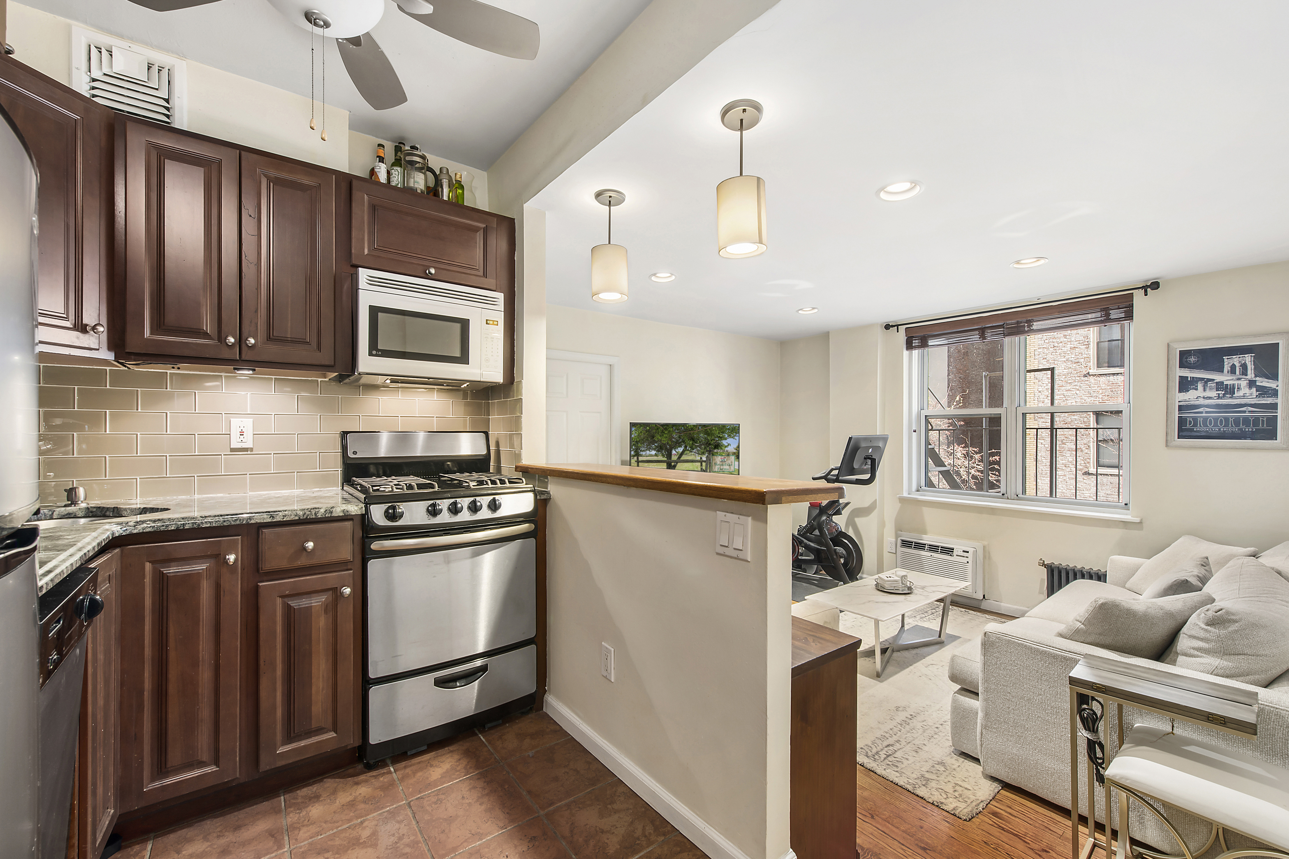131 West 85th Street, Unit 2A Manhattan, NY 10024 - Photo 2 of 6 a kitchen with stainless steel appliances granite countertop a stove top oven a sink dishwasher a refrigerator and cabinets with wooden floor