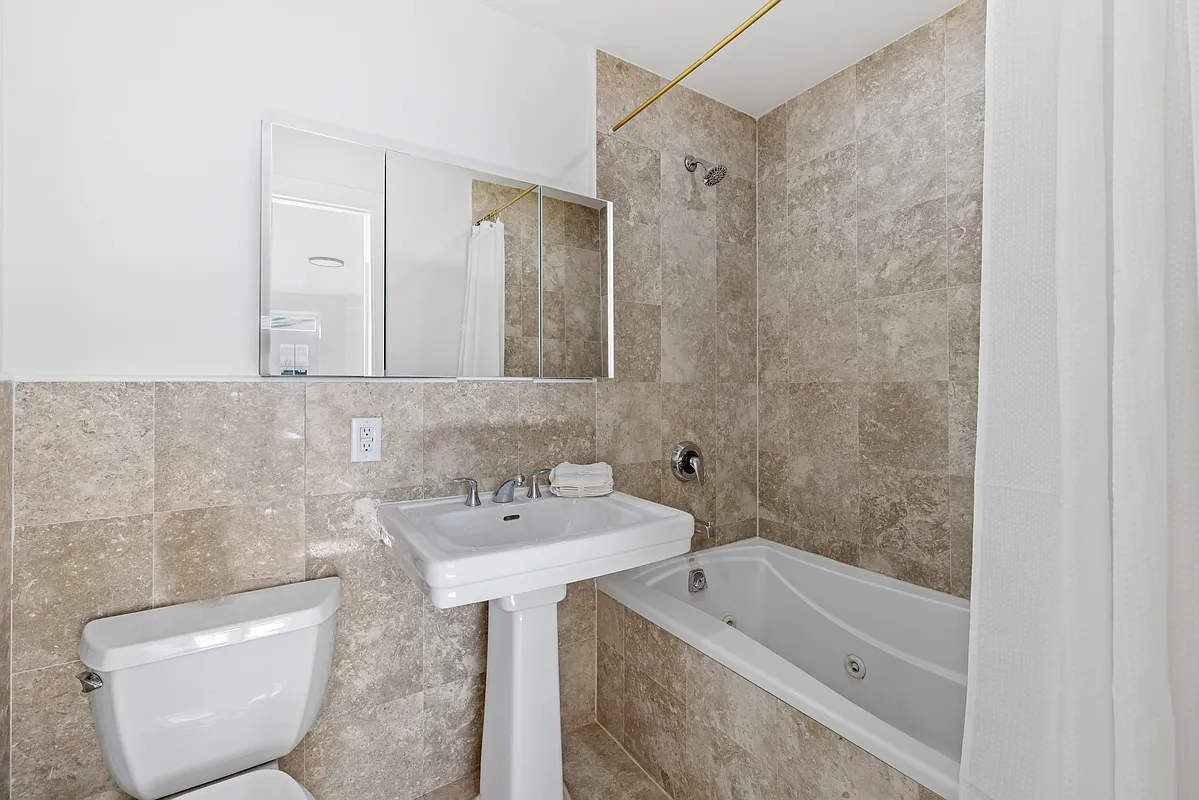 310 2nd Street, Unit 3C Brooklyn, NY 11215 - Photo 12 of 14 a bathroom with a sink a toilet and bathtub