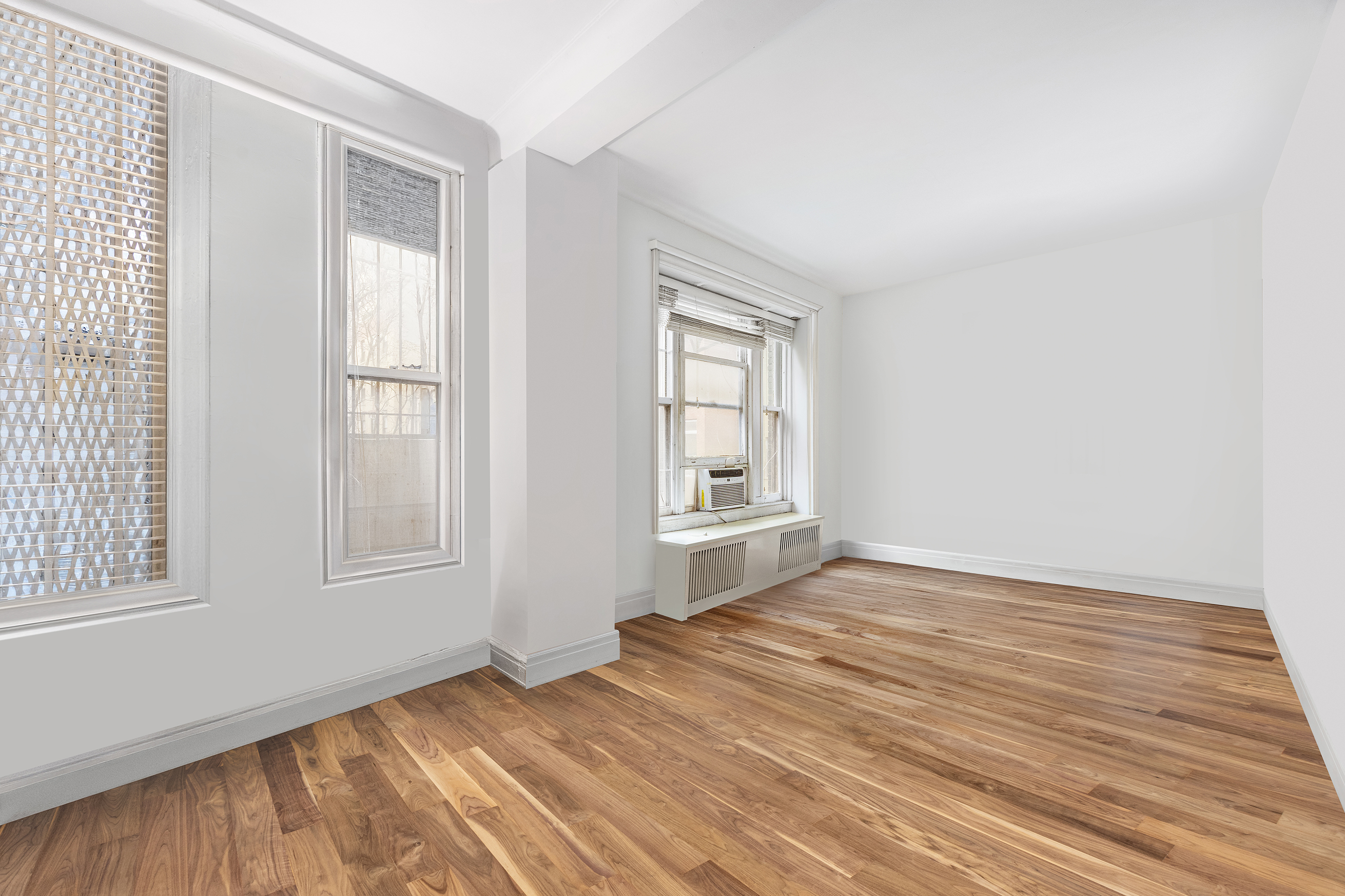 525 Park Avenue, Unit 3D Manhattan, NY 10065 - Photo 5 of 9 an empty room with wooden floor and windows