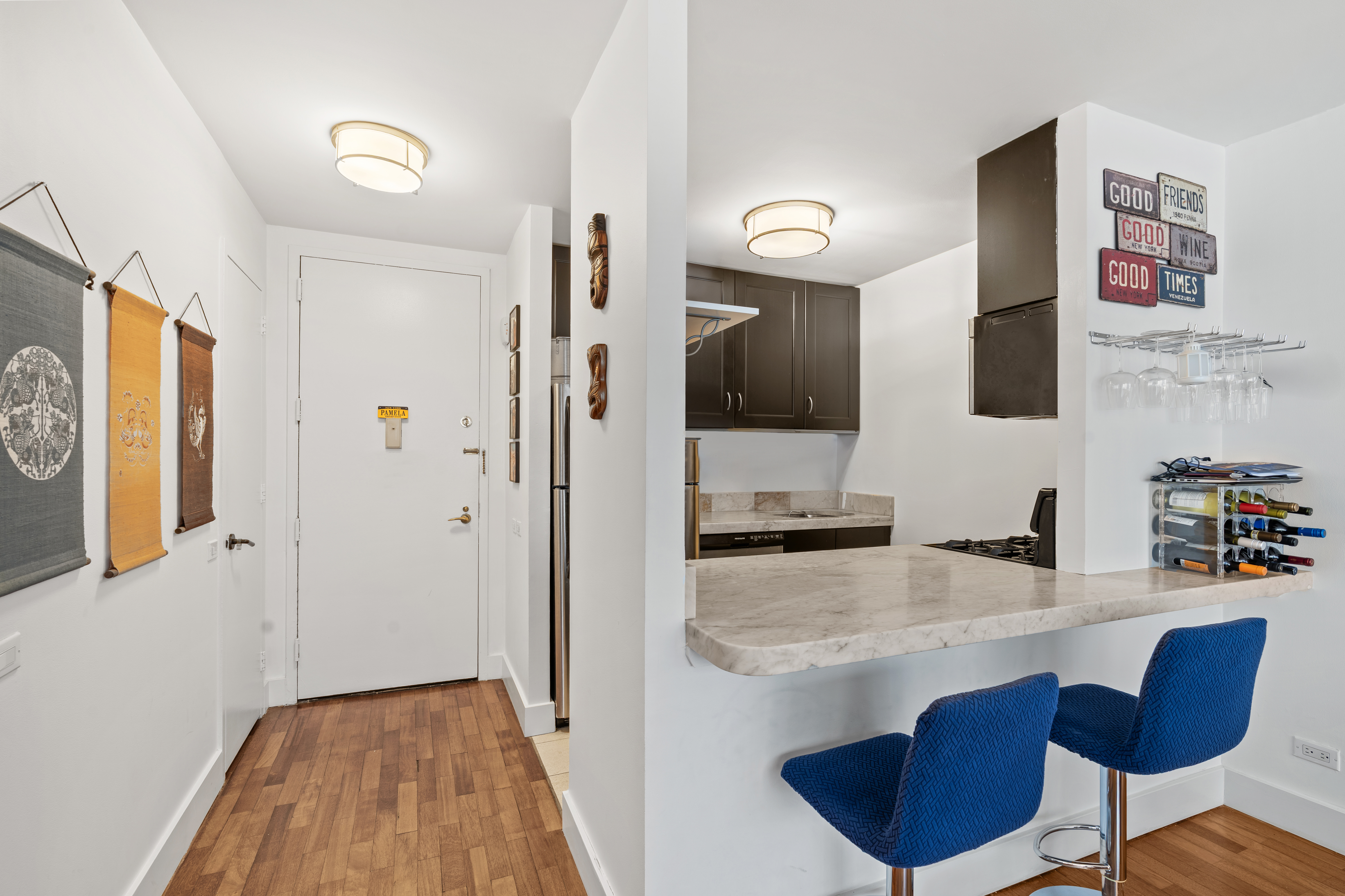 330 East 75th Street, Unit 4K Manhattan, NY 10021 - Photo 4 of 9 a kitchen with stainless steel appliances granite countertop a sink and cabinets