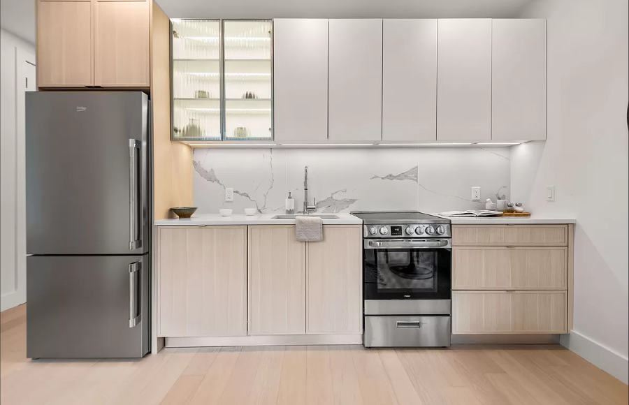 218 Front Street, Unit 231 Brooklyn, NY 11201 - Photo 7 of 35 a kitchen with stainless steel appliances granite countertop a refrigerator sink and cabinets