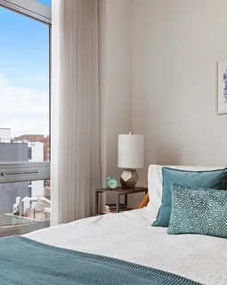 a bedroom with a bed and a night stand