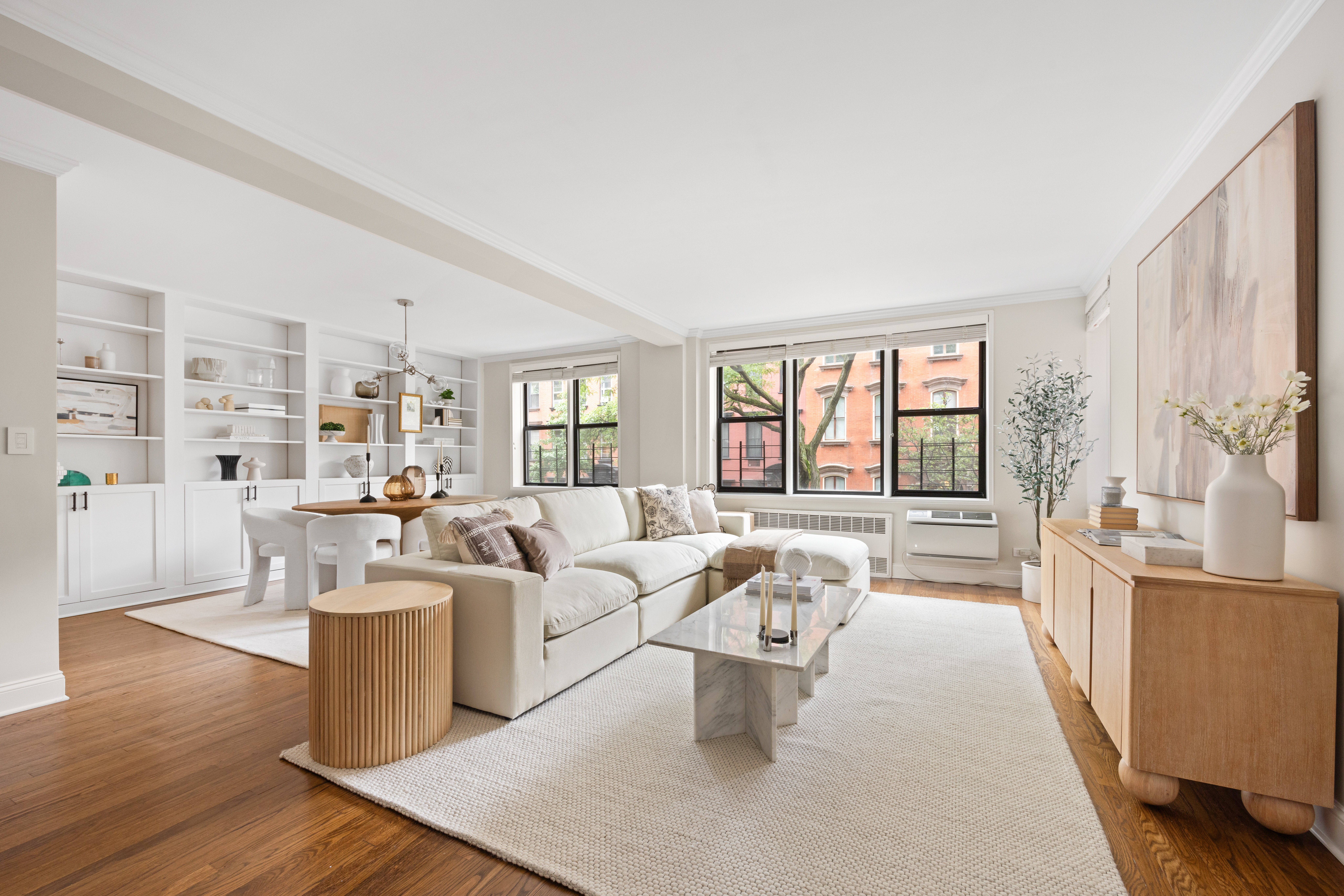 211 East 18th Street, Unit 2O Manhattan, NY 10003 - Photo 2 of 14 a living room with furniture large window and wooden floor