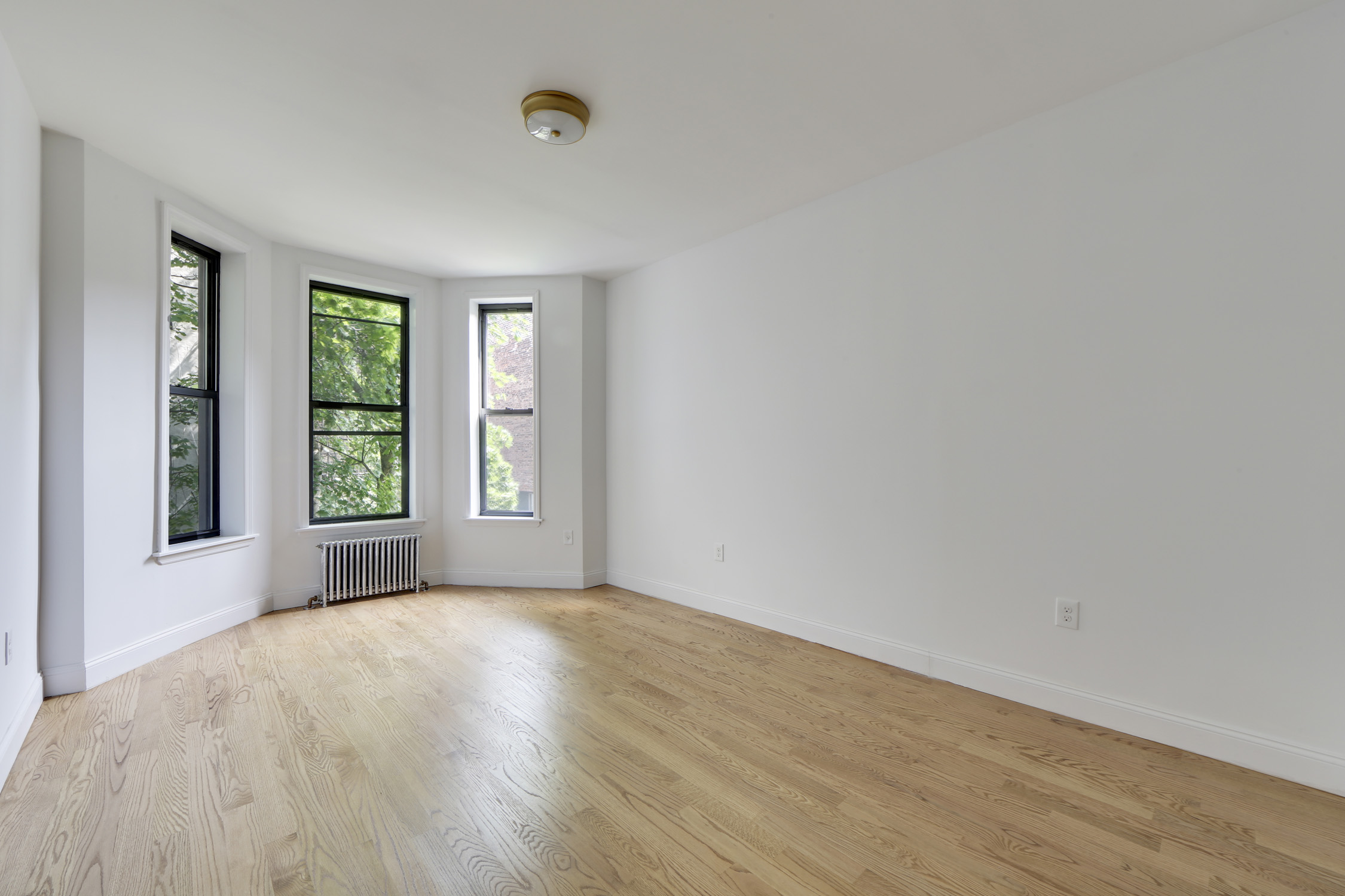 1499 Union Street, Unit 2 Brooklyn, NY 11213 - Photo 8 of 11 a view of empty room with wooden floor and fan