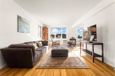 a living room with furniture rug and wooden floor