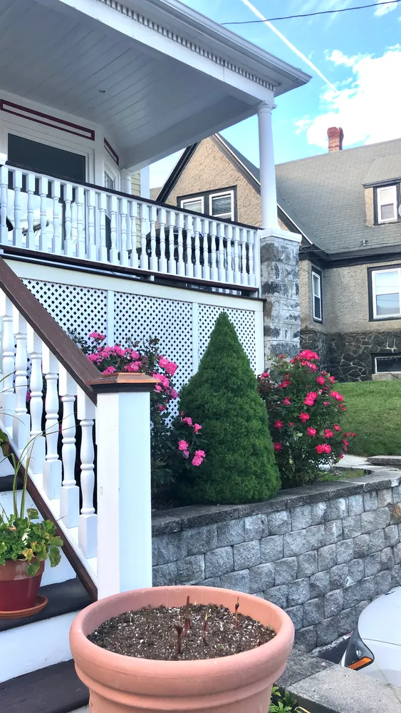 a front view of a house with a garden