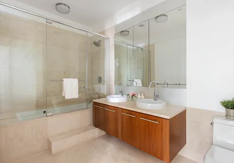 a bathroom with a tub sink and mirror