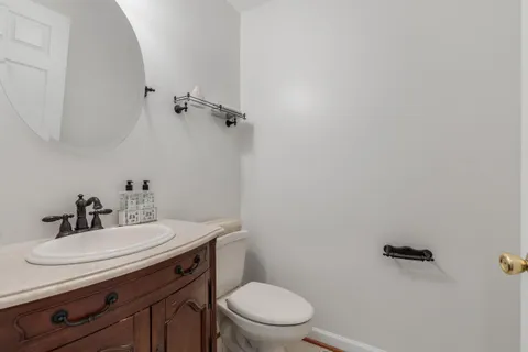 a bathroom with a sink a toilet and a mirror