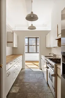 a kitchen with stainless steel appliances a stove a sink and a refrigerator