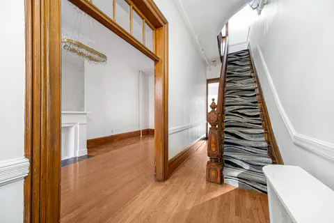 a view of an entryway with wooden floor