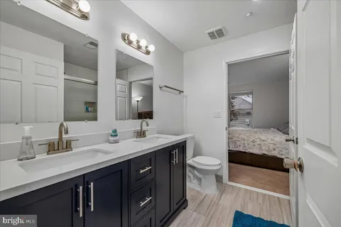 a bathroom with a double vanity sink and a mirror