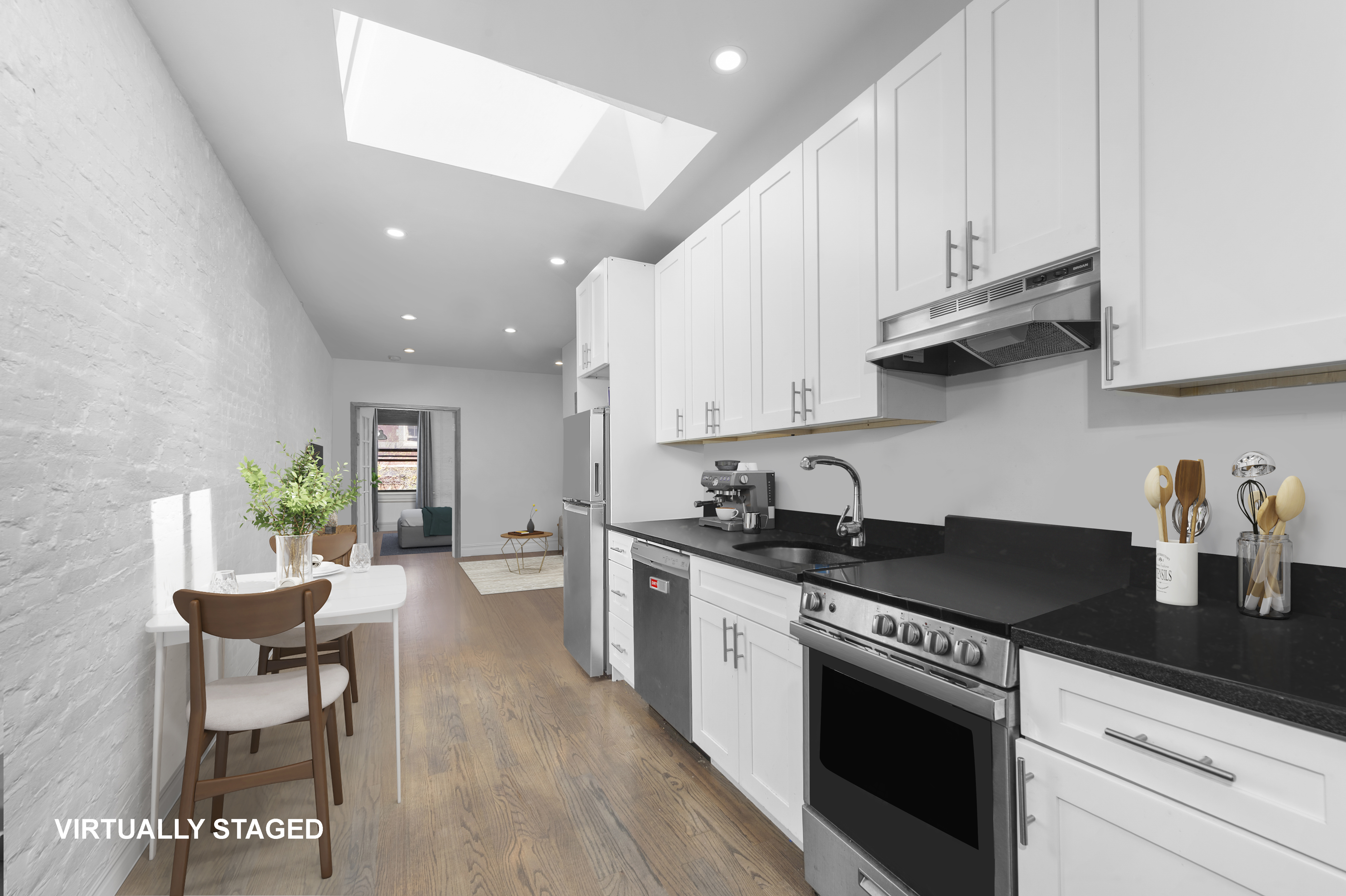 a kitchen with stainless steel appliances granite countertop a stove a sink a refrigerator and white cabinets