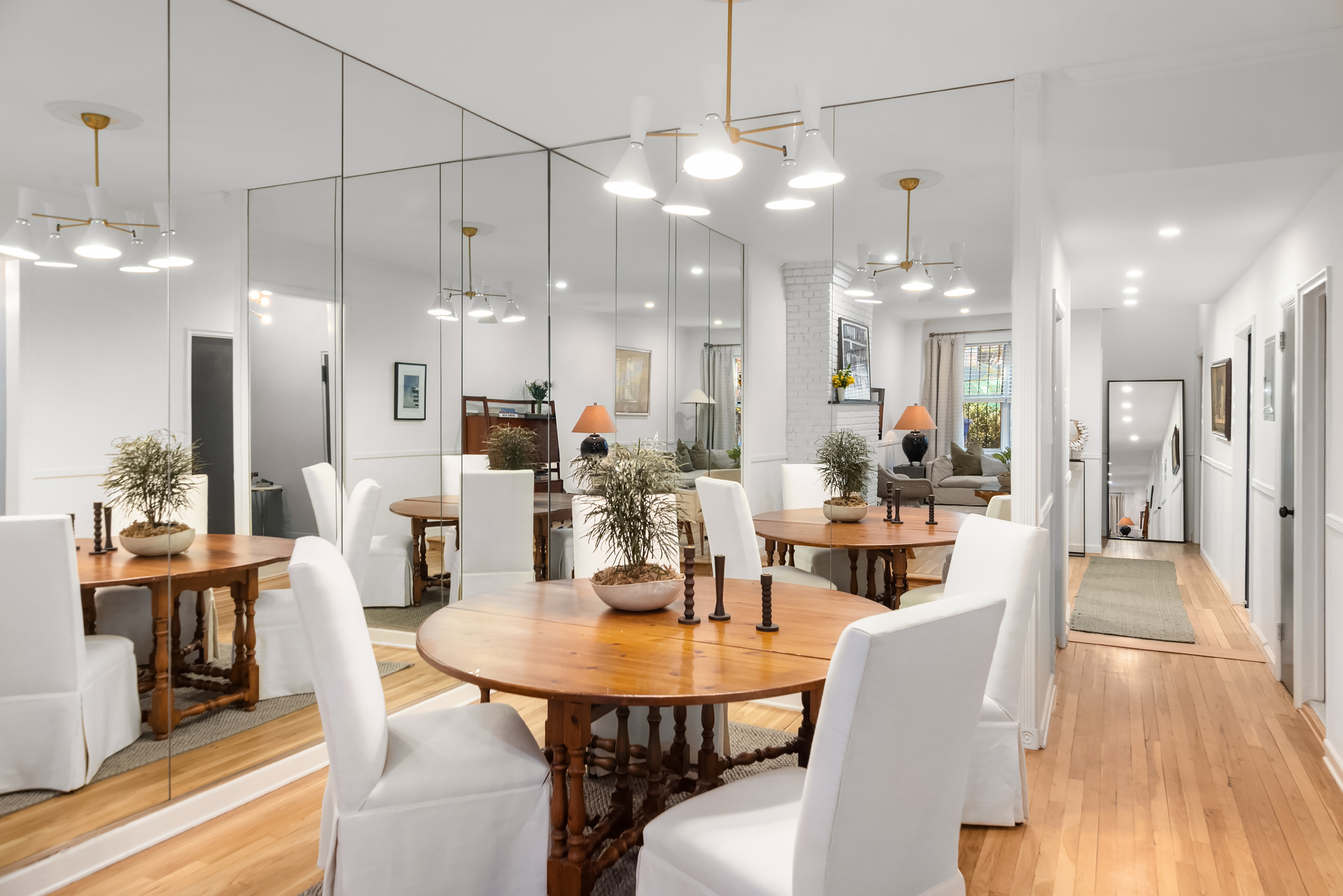 159 West 13th Street Manhattan, NY 10011 - Photo 6 of 36 a view of a dining room and livingroom with furniture wooden floor a chandelier