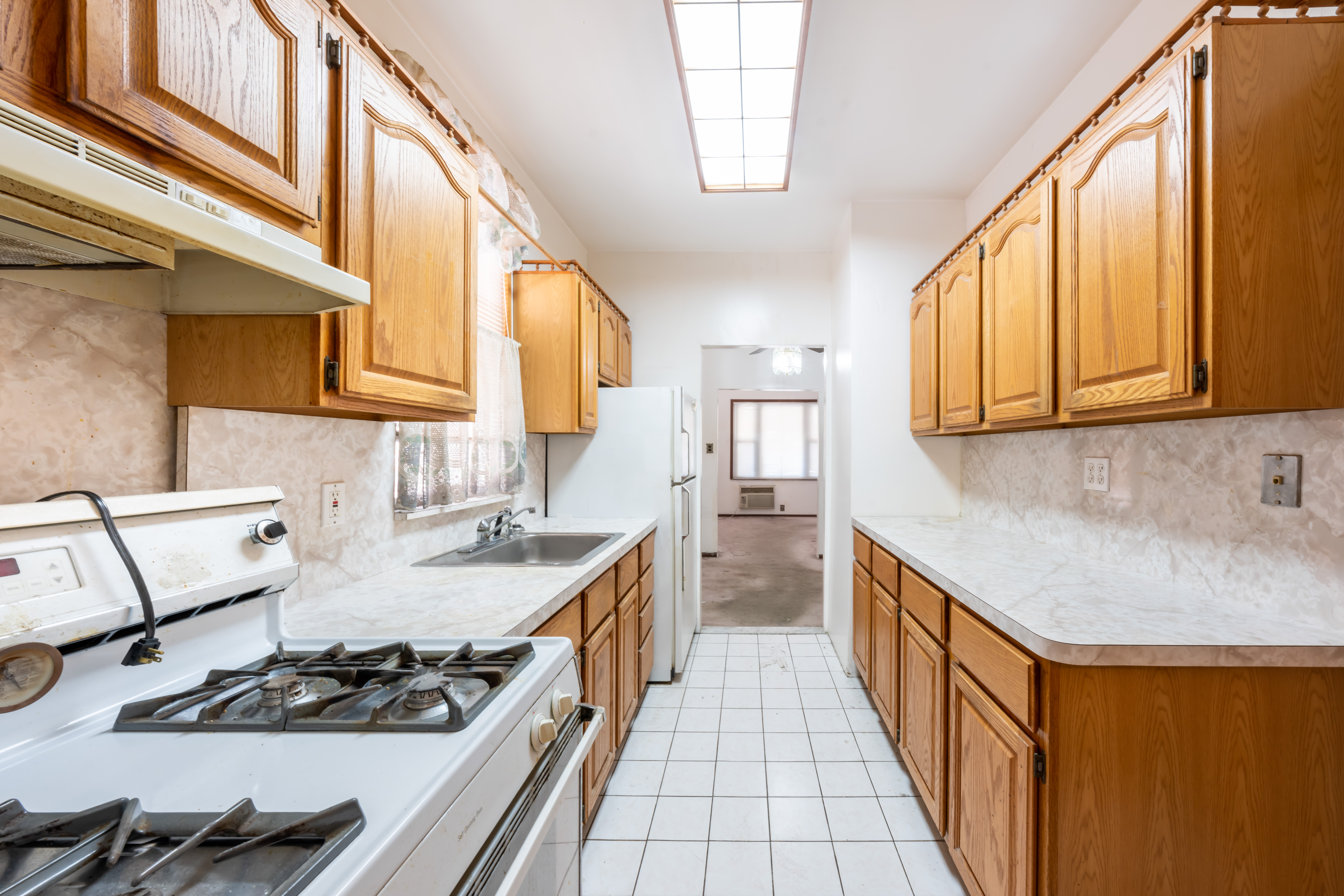 1085 Arnow Avenue Bronx, NY 10469 - Photo 4 of 16 a kitchen with stainless steel appliances granite countertop a sink stove and cabinets