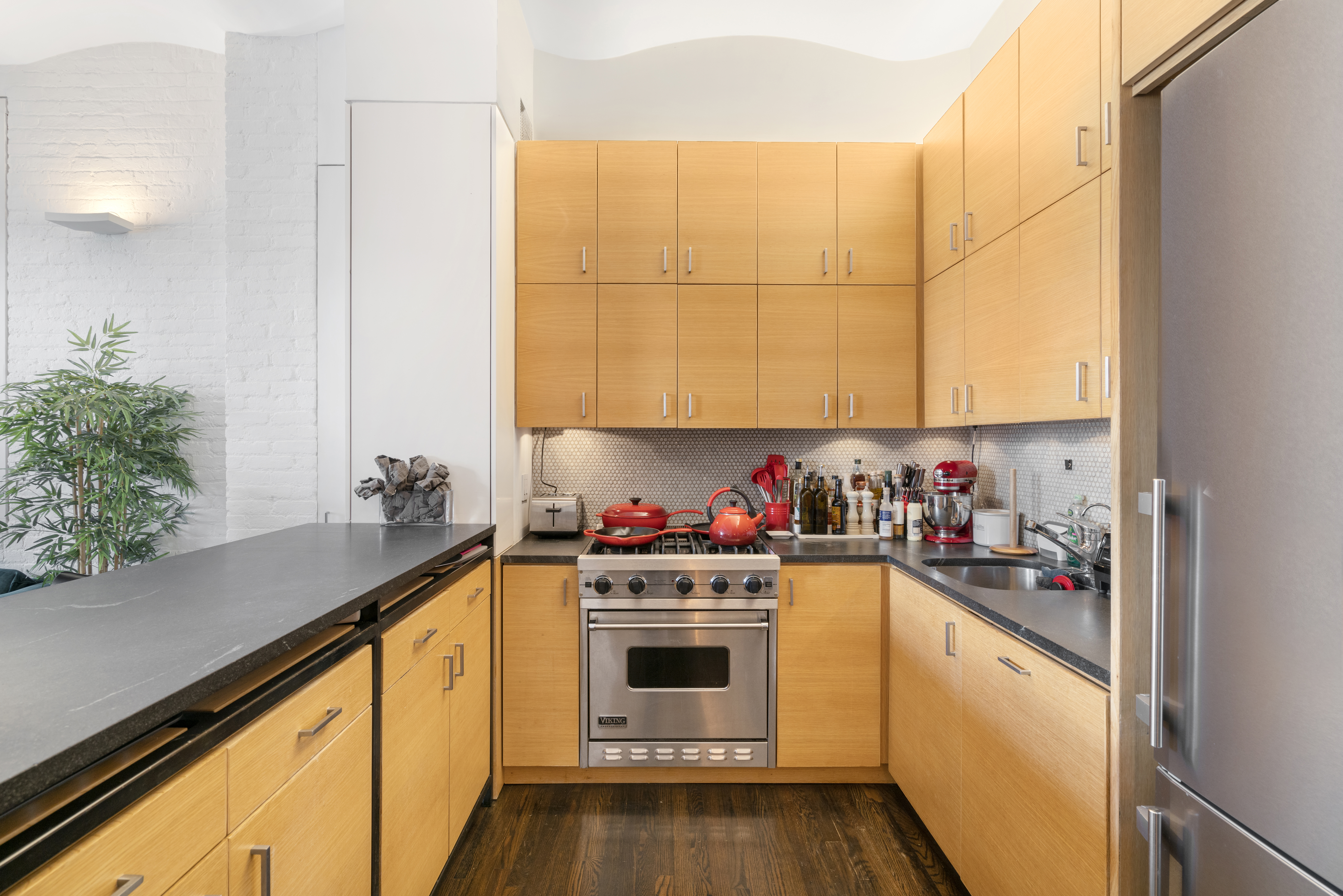 312 East 23rd Street, Unit 7B Manhattan, NY 10010 - Photo 4 of 14 a kitchen with stainless steel appliances a stove and a refrigerator