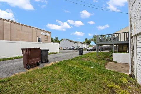 a view of an house with backyard and furniture