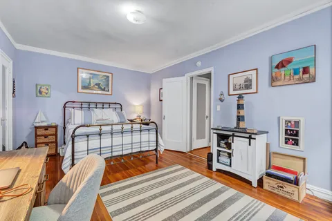 a bedroom with furniture and wooden floor