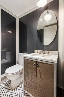a bathroom with a sink a toilet and mirror