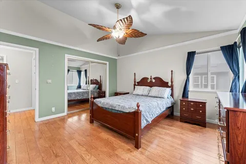 a spacious bedroom with a bed and a chandelier