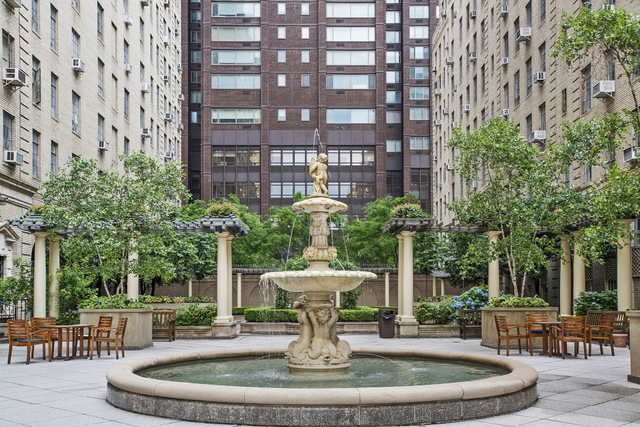 340 West 57th Street, Unit 8E Manhattan, NY 10019 - Photo 15 of 16 a view of a building with a fountain in a patio