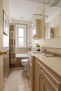 a spacious bathroom with a granite countertop sink toilet and shower