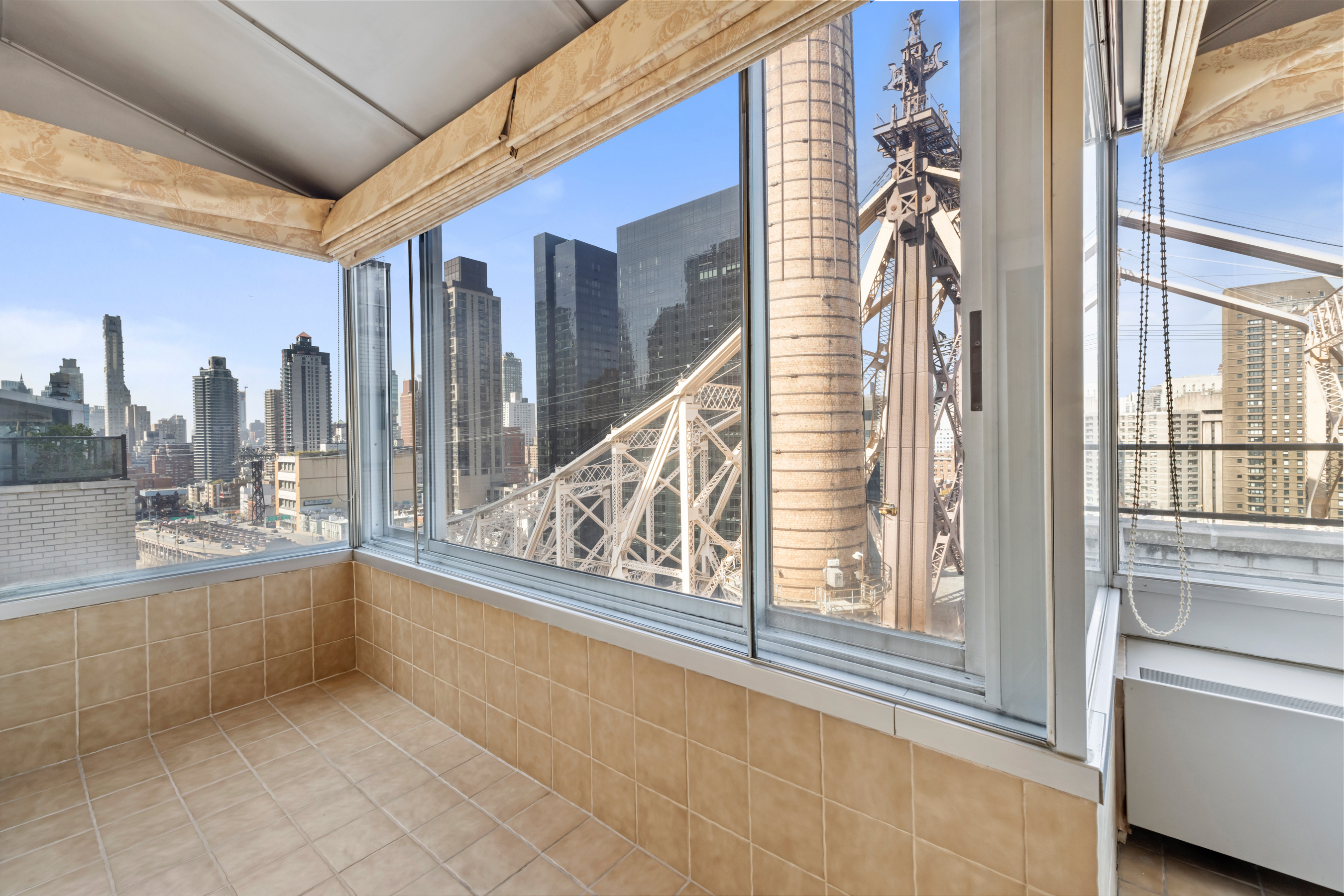 35 Sutton Place, Unit PHB Manhattan, NY 10022 - Photo 8 of 14 a view of a living room with a couch and large windows