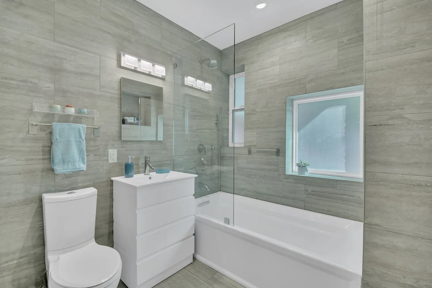 a bathroom with a toilet a sink and bathtub