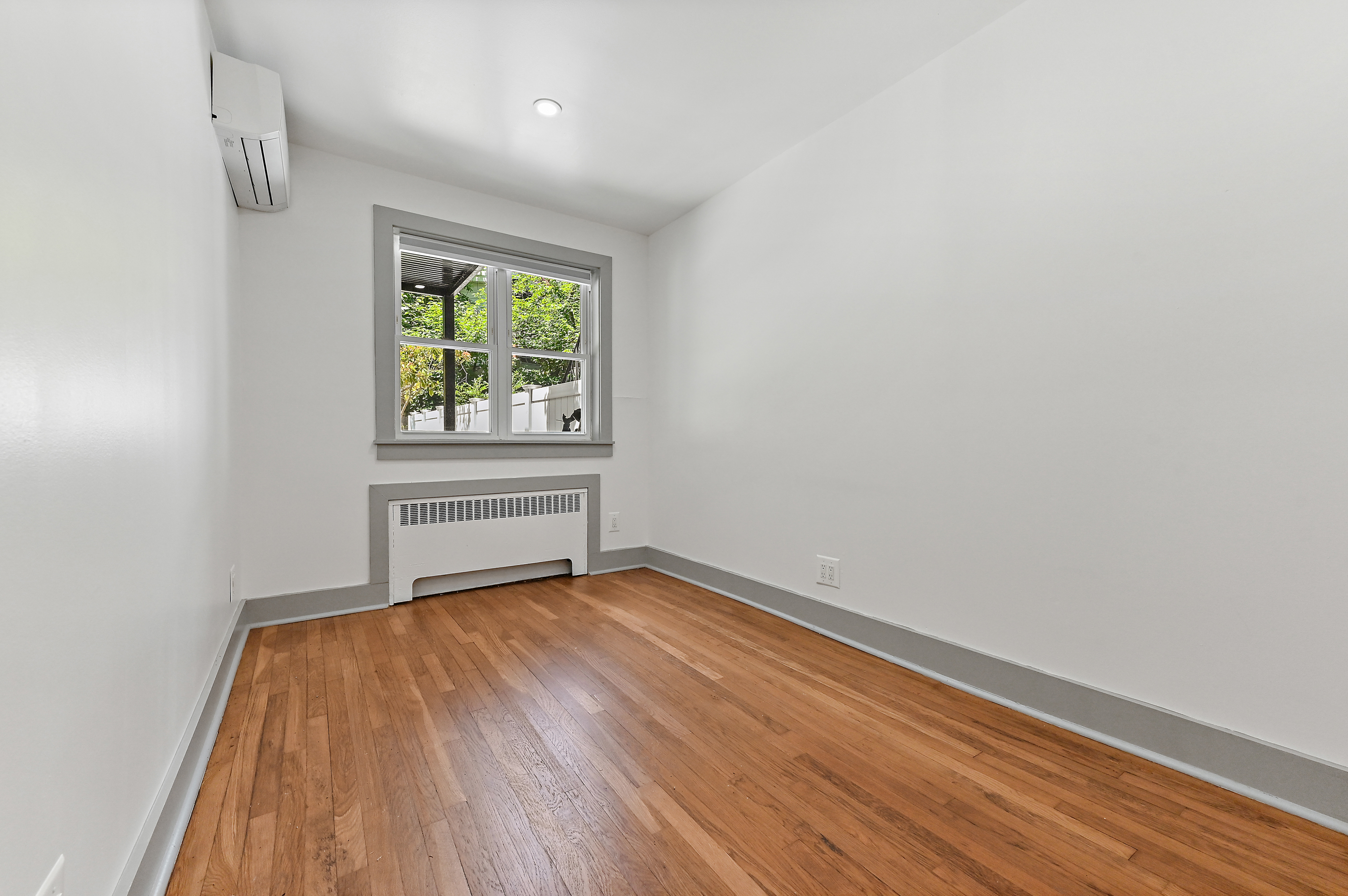 5823 Fieldston Road, Unit 1A Bronx, NY 10471 - Photo 11 of 26 a view of an empty room with wooden floor and a window