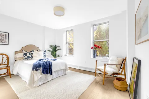 a bedroom with bed and a window