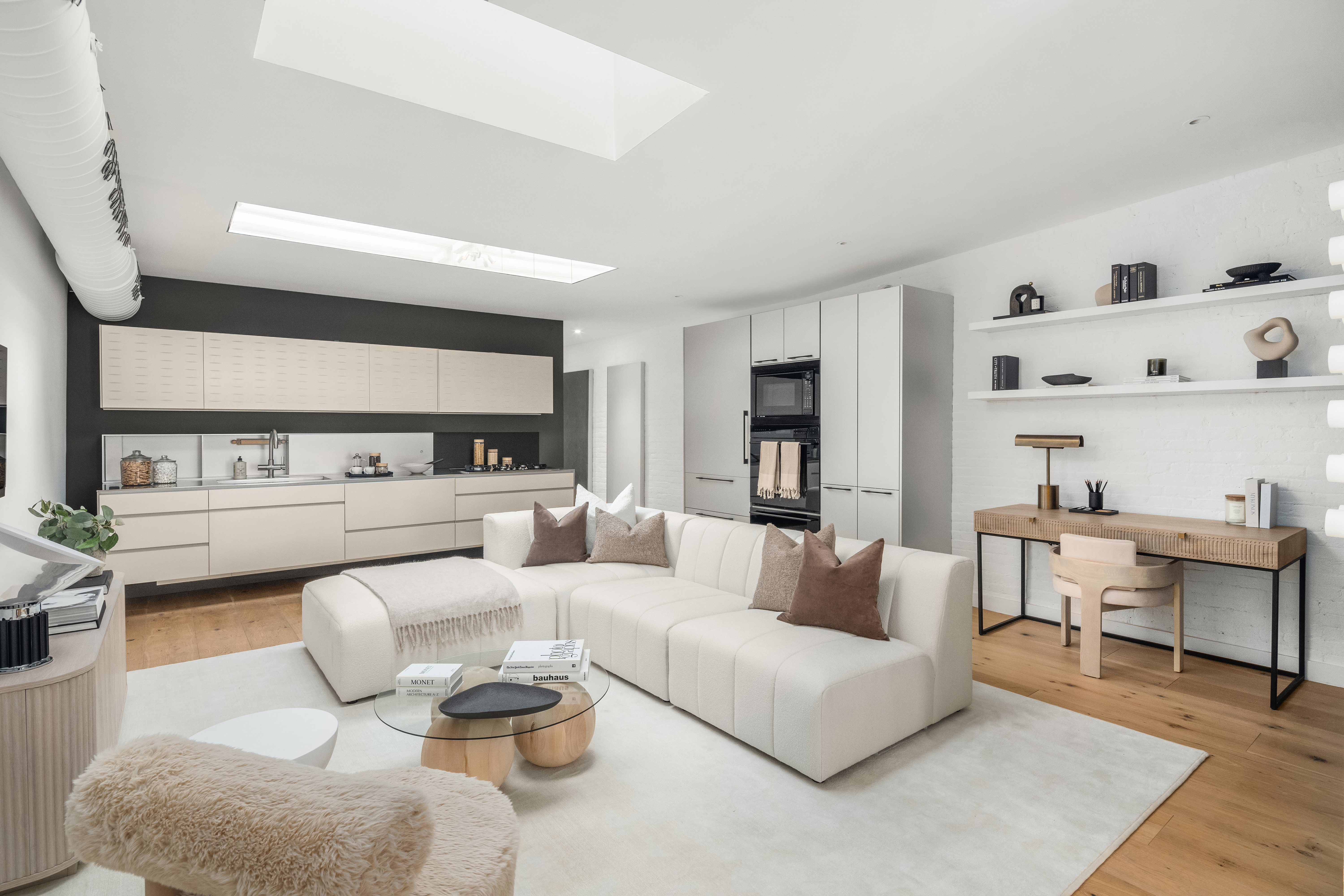 472 Greenwich Street, Unit PH Manhattan, NY 10013 - Photo 2 of 13 a living room with furniture a rug and a large window