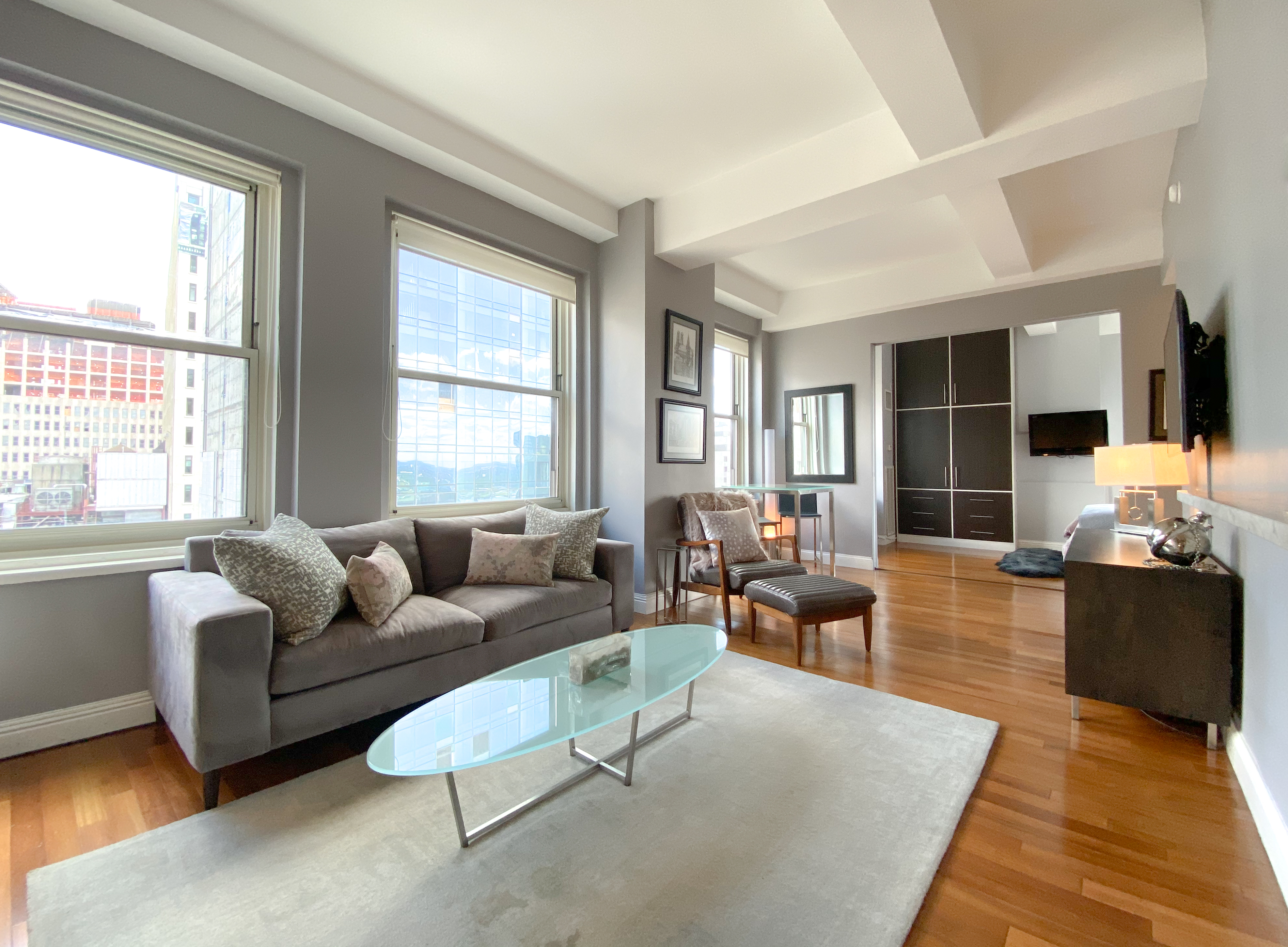 88 Greenwich Street, Unit 3005 Manhattan, NY 10006 - Photo 1 of 7 a living room with furniture wooden floor and windows