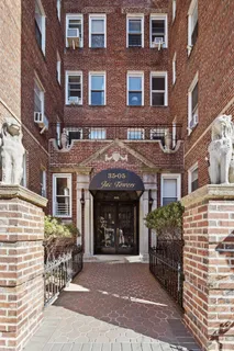 a front view of a brick building with many windows